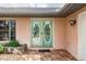 Double door entry with glass inserts and terracotta tile flooring at 2216 Pellam Blvd, Port Charlotte, FL 33948