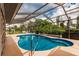 Enjoy this refreshing pool with a screened enclosure, ideal for swimming and sunbathing at 2216 Pellam Blvd, Port Charlotte, FL 33948