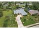 Aerial view of a canal-front house with a large yard at 2216 Pellam Blvd, Port Charlotte, FL 33948