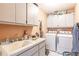 Convenient laundry room with washer, dryer, and utility sink at 2216 Pellam Blvd, Port Charlotte, FL 33948