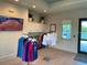 Community room with clothing displays and large TV at 14194 Heritage Landing Blvd # 624, Punta Gorda, FL 33955