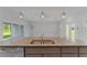 Kitchen island with granite countertop and double sink at 9461 Attica Cir, Port Charlotte, FL 33981