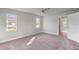 Charming bedroom with neutral carpeting and two windows at 9461 Attica Cir, Port Charlotte, FL 33981
