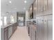 Modern kitchen with gray cabinets and granite countertops at 9461 Attica Cir, Port Charlotte, FL 33981