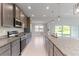 Open concept kitchen with granite island and stainless steel appliances at 9461 Attica Cir, Port Charlotte, FL 33981