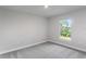 Bright bedroom featuring a large window and wall-to-wall carpet at 9461 Attica Cir, Port Charlotte, FL 33981