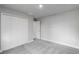 Well-lit bedroom with double door closet and gray carpeting at 9461 Attica Cir, Port Charlotte, FL 33981