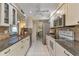 Modern kitchen featuring granite countertops and white cabinets at 286 Mark Twain Ln, Rotonda West, FL 33947