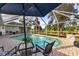 Inviting pool area with patio furniture and lush landscaping at 286 Mark Twain Ln, Rotonda West, FL 33947