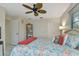 Bedroom with king-size bed, ceiling fan, and ample closet space at 286 Mark Twain Ln, Rotonda West, FL 33947
