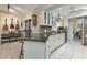 Kitchen with breakfast bar, granite counters, and white cabinets at 286 Mark Twain Ln, Rotonda West, FL 33947