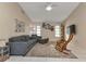 Spacious living room with sectional sofa, rocking chair, and large TV at 286 Mark Twain Ln, Rotonda West, FL 33947