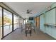 Screened lanai with pool view, ceiling fan, and dining area at 286 Mark Twain Ln, Rotonda West, FL 33947