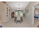 Elegant dining room with a chandelier and view of the pool at 286 Mark Twain Ln, Rotonda West, FL 33947