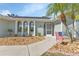 Inviting light teal home with landscaped yard and walkway at 286 Mark Twain Ln, Rotonda West, FL 33947