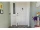 Inviting front entry with white door and unique knocker at 286 Mark Twain Ln, Rotonda West, FL 33947