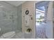 Bathroom with pool view, walk-in shower, and modern fixtures at 286 Mark Twain Ln, Rotonda West, FL 33947