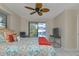 Main bedroom with pool view, king-size bed, and ceiling fan at 286 Mark Twain Ln, Rotonda West, FL 33947