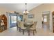 Bright dining room with table, chairs, and view of the pool at 286 Mark Twain Ln, Rotonda West, FL 33947