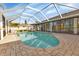 Relaxing kidney-shaped pool with a screened enclosure at 286 Mark Twain Ln, Rotonda West, FL 33947