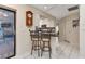 Kitchen nook with two bar stools and a view of the backyard at 286 Mark Twain Ln, Rotonda West, FL 33947