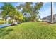 Private backyard oasis with lush landscaping and pond views at 286 Mark Twain Ln, Rotonda West, FL 33947