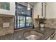 Kitchen sink with granite countertop and view of the pool at 286 Mark Twain Ln, Rotonda West, FL 33947