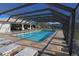 Community pool with covered patio and lounge chairs for relaxation at 26485 Rampart Blvd # D6, Punta Gorda, FL 33983