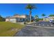 Building exterior showcasing landscaping and parking area at 26485 Rampart Blvd # D6, Punta Gorda, FL 33983