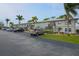 Exterior of condo building with parking and landscaping at 26485 Rampart Blvd # D6, Punta Gorda, FL 33983
