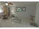 Living room with glass coffee table and tiled floors at 26485 Rampart Blvd # D6, Punta Gorda, FL 33983