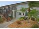 Condo building with a stairway and landscaping at 26485 Rampart Blvd # D6, Punta Gorda, FL 33983