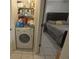 Compact laundry room with a washer and dryer, plus storage shelving at 26485 Rampart Blvd # D6, Punta Gorda, FL 33983
