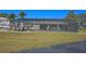 Community pool with screened enclosure and patio furniture at 26485 Rampart Blvd # D6, Punta Gorda, FL 33983