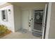 Condo building entry with two doors and a fire extinguisher at 26485 Rampart Blvd # D6, Punta Gorda, FL 33983