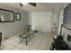 Living room with tiled floors, glass coffee table, and TV at 26485 Rampart Blvd # D6, Punta Gorda, FL 33983