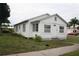 White house with front yard, steps, and small plants at 702 W Olympia Ave, Punta Gorda, FL 33950