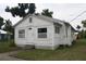 White house with front yard, steps, and small plants at 702 W Olympia Ave, Punta Gorda, FL 33950