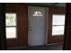 Charming sunroom with white door and wood paneling at 702 W Olympia Ave, Punta Gorda, FL 33950