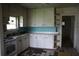 White cabinets and turquoise backsplash in this dated kitchen are ready for updates at 702 W Olympia Ave, Punta Gorda, FL 33950
