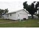 White house with side yard, ramp, and mature trees at 702 W Olympia Ave, Punta Gorda, FL 33950