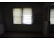 A living room with two windows and built-in shelving needs renovation at 702 W Olympia Ave, Punta Gorda, FL 33950