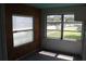 Bright sunroom with wood paneling and multiple windows at 702 W Olympia Ave, Punta Gorda, FL 33950