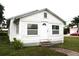 White house with front yard, steps, and small plants at 702 W Olympia Ave, Punta Gorda, FL 33950