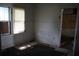 Simple bedroom with window and damaged flooring at 702 W Olympia Ave, Punta Gorda, FL 33950