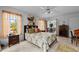 Inviting bedroom filled with light, featuring tiled floors, a ceiling fan, and a cozy bed at 196 Lecturn St, Port Charlotte, FL 33954