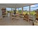 Bright sunroom with a table, chairs, and view of the backyard at 22557 Bolanos Ct, Port Charlotte, FL 33952