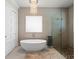 Modern bathroom with a freestanding soaking tub, walk-in shower, and chandelier at 2511 Rio Largo Ct, Punta Gorda, FL 33950