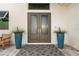 Double front doors with sidelights, flanked by teal planters at 2511 Rio Largo Ct, Punta Gorda, FL 33950