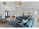 Spacious living room with hardwood floors, sectional sofa, and large TV at 2511 Rio Largo Ct, Punta Gorda, FL 33950